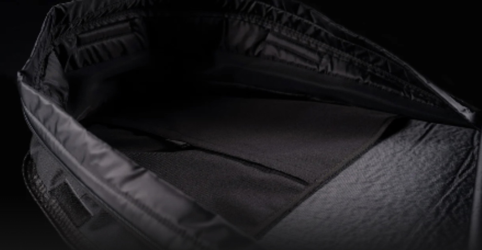 Close-up inside an open black board bag showing the padded interior lining